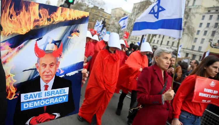 Israeli protestors wearing red capes like characters from the Handmade's Tale